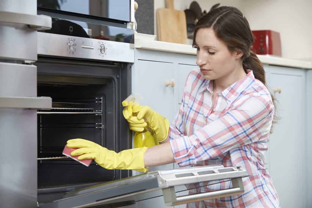 woman cleaning oven