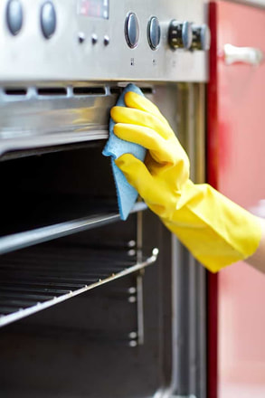 woman cleaning oven in Peterborough Ontario